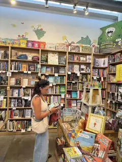 Traductora en una librería rodeada de libros en varios idiomas